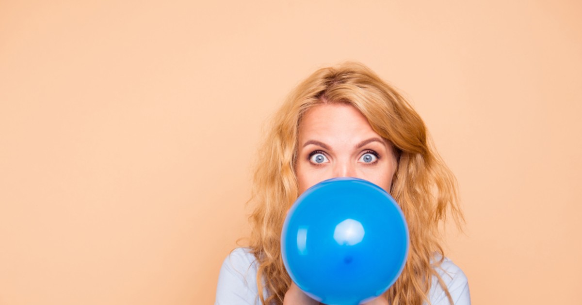 Girl Blowing Balloons